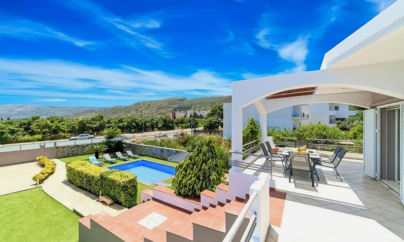 Elevated view over the pool and hills near Villa Morea